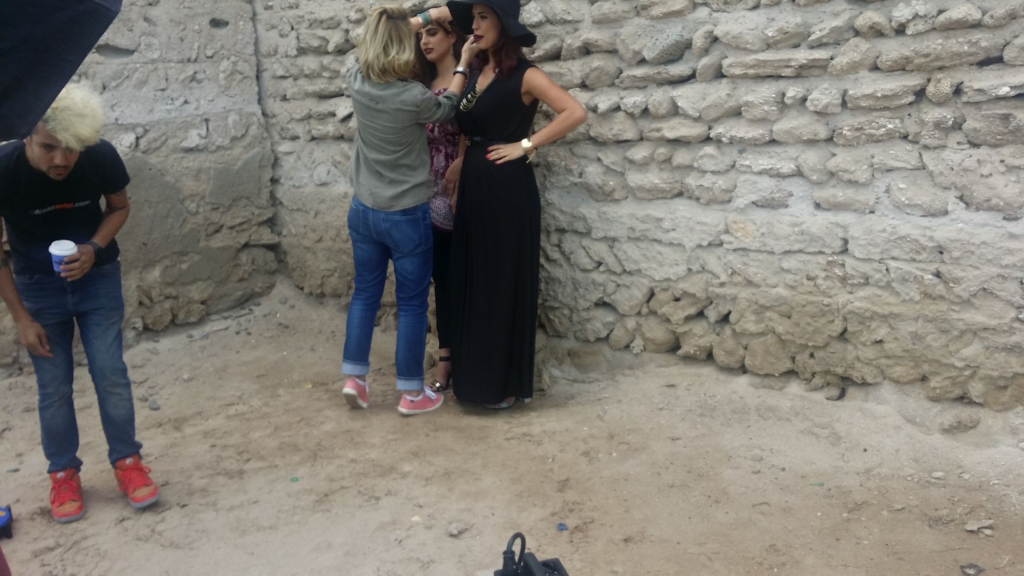 Fashion photoshoot against coral stone.